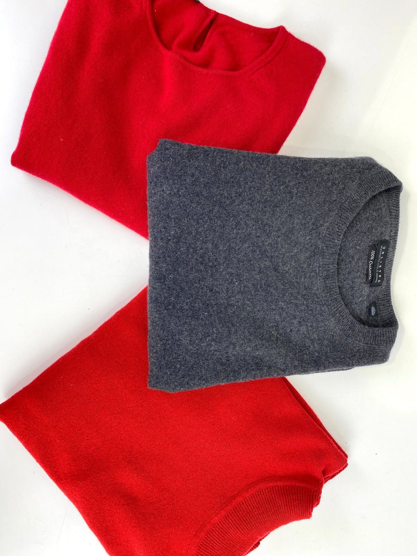 vintage cashmere sweaters folded. red and grey jumpers. Ian Drummond Vintage. 