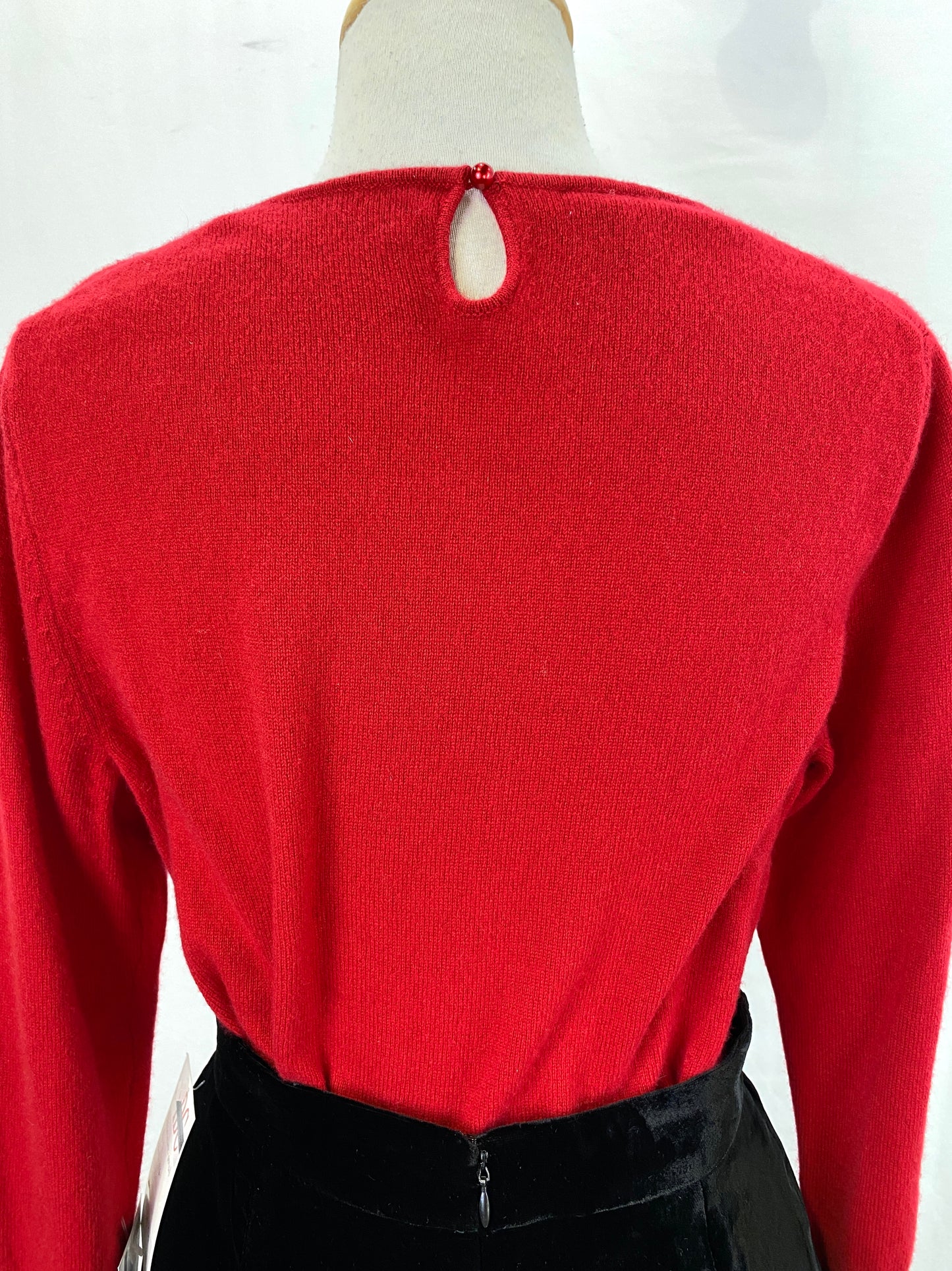 Back of red vintage cashmere sweater showing keyhole opening with button at back of neck. Ian Drummond Vintage.
