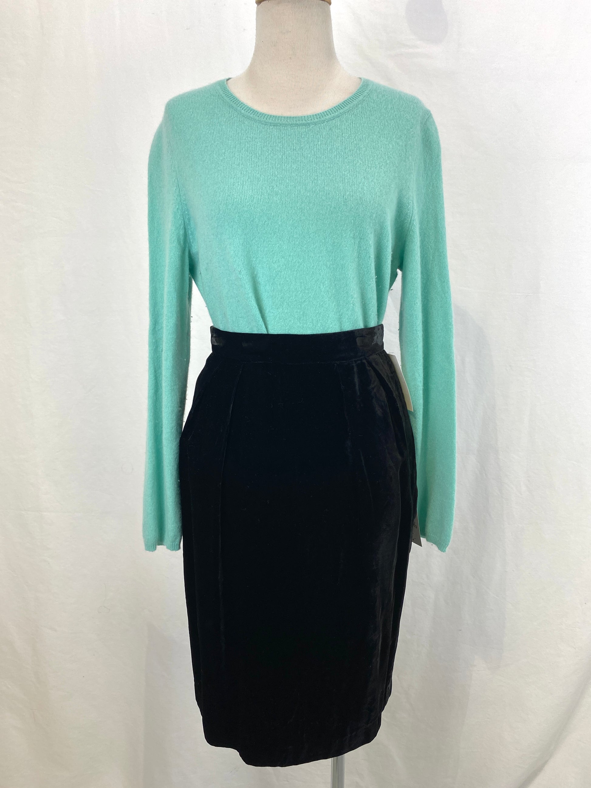A vintage green cashmere sweater tucked into a black skirt. Ian Drummond Vintage. 