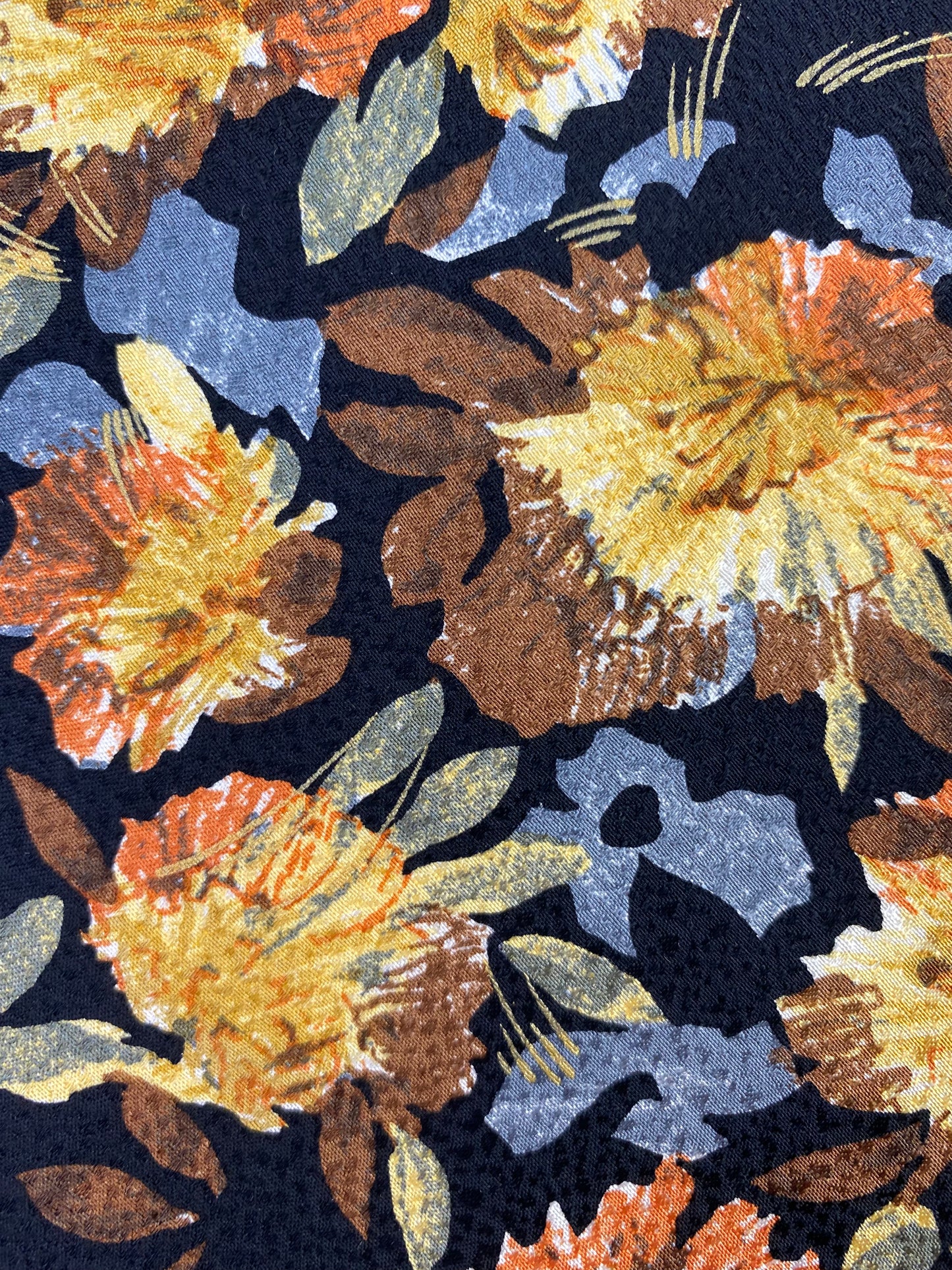 Close-up pattern detail of: 90s Deadstock Silk Necktie, Men's Vintage Gold Blue Floral Pattern Tie, Black Background, NOS