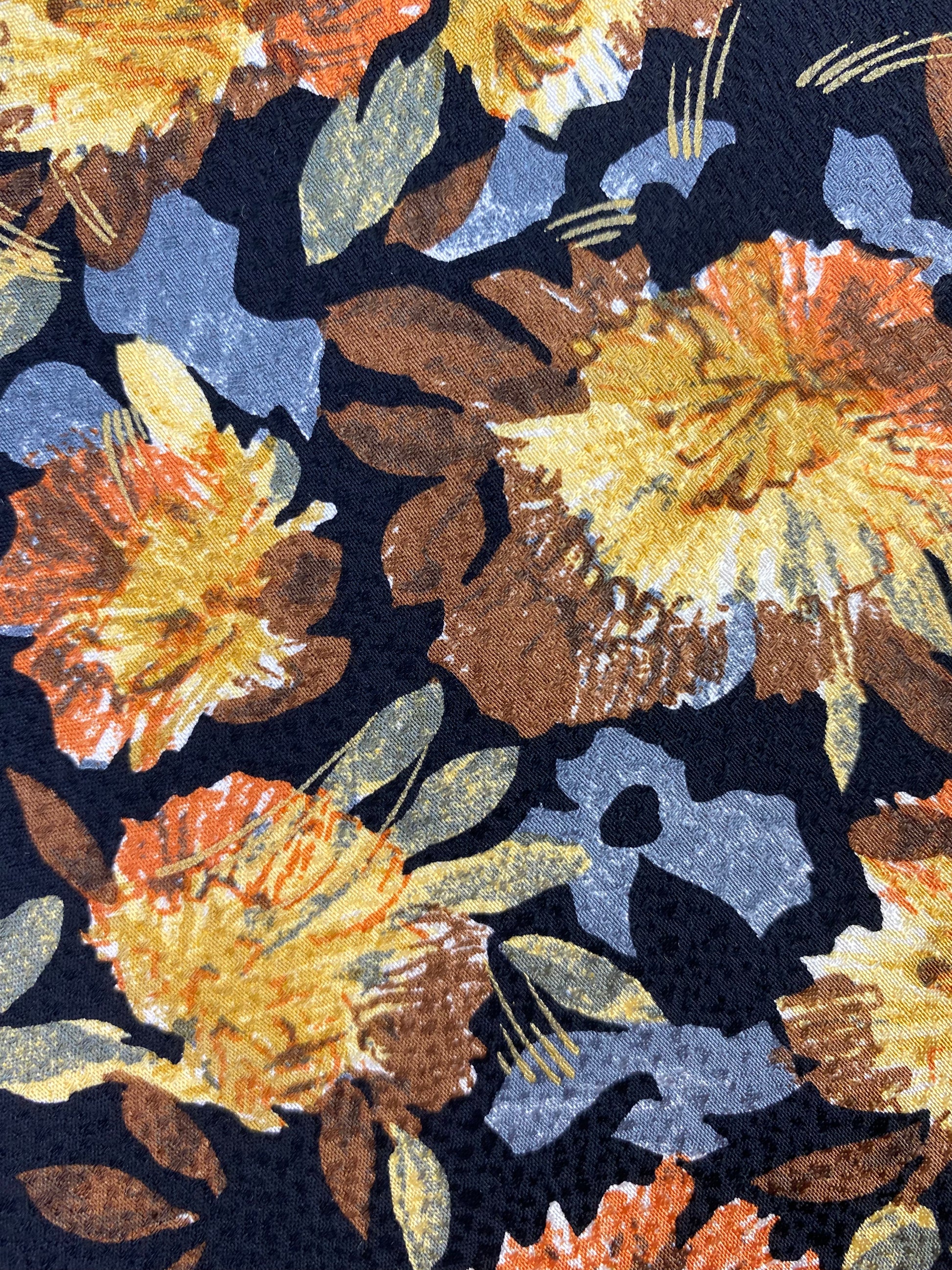 Close-up pattern detail of: 90s Deadstock Silk Necktie, Men's Vintage Gold Blue Floral Pattern Tie, Black Background, NOS