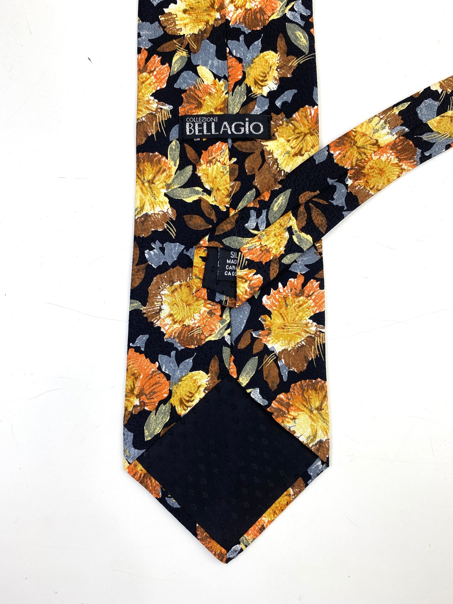 Back and labels of: 90s Deadstock Silk Necktie, Men's Vintage Gold Blue Floral Pattern Tie, Black Background, NOS