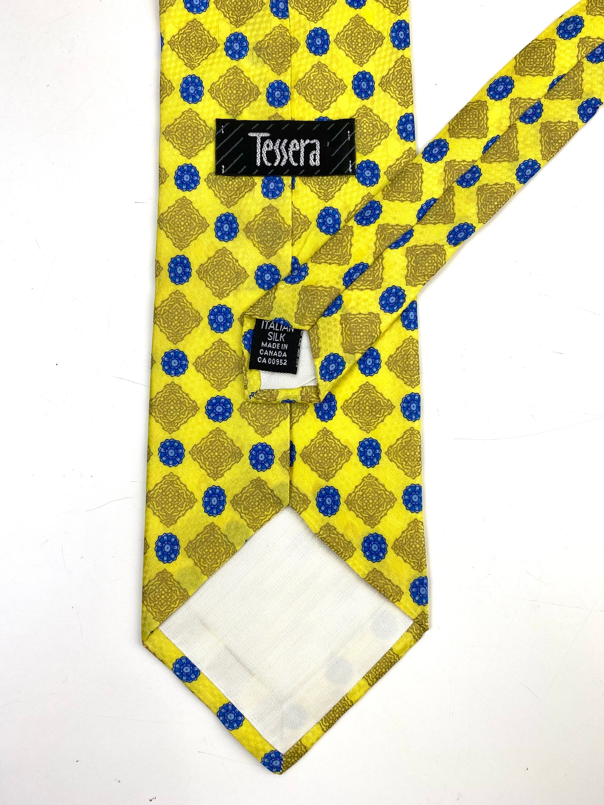Back and labels of: 90s Deadstock Silk Necktie, Men's Vintage Yellow/Gold/Blue Medallion Pattern Tie, NOS