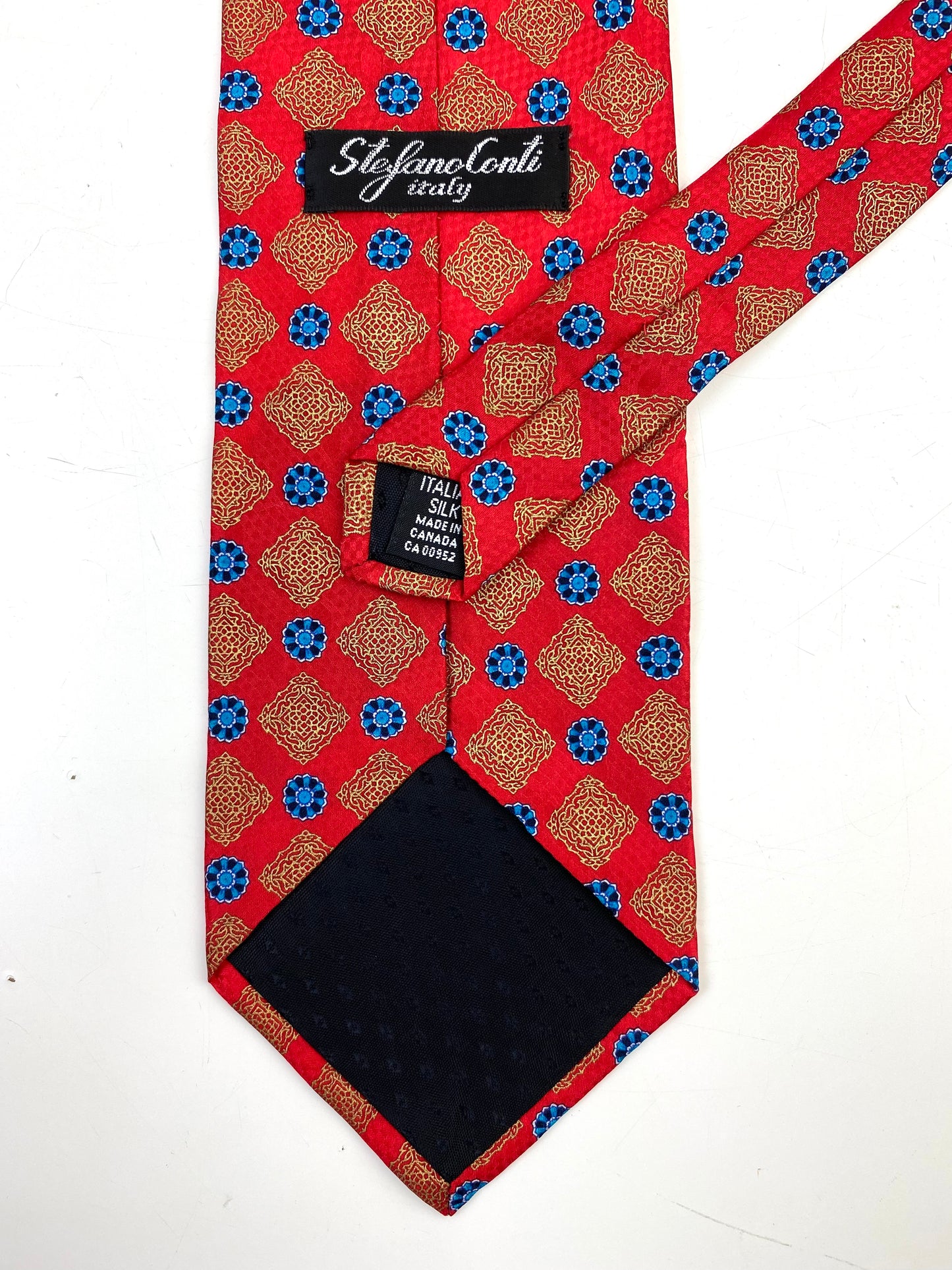 Back and labels of: 90s Deadstock Silk Necktie, Men's Vintage Red/Blue Medallion Pattern Tie, NOS