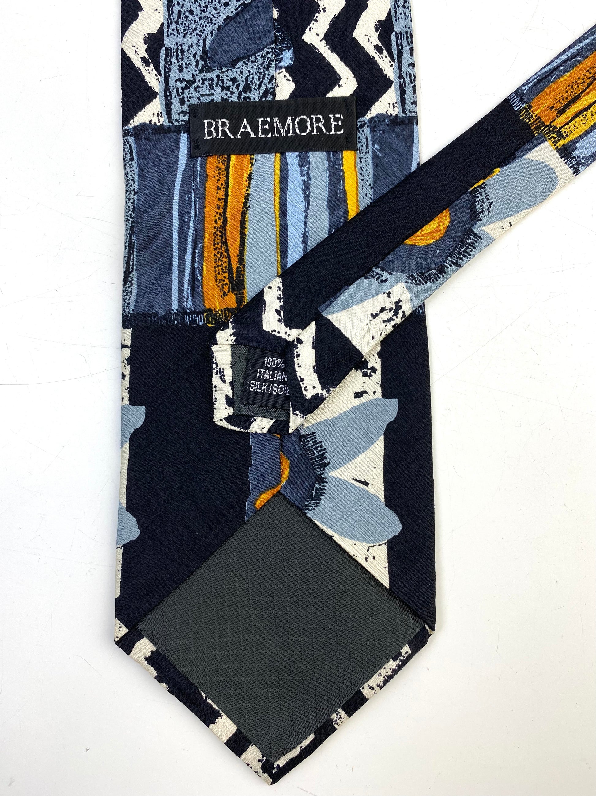 Back and labels of: 90s Deadstock Silk Necktie, Men's Vintage Gold/ Blue/ Black/ White Chevron Floral Pattern Tie, NOS