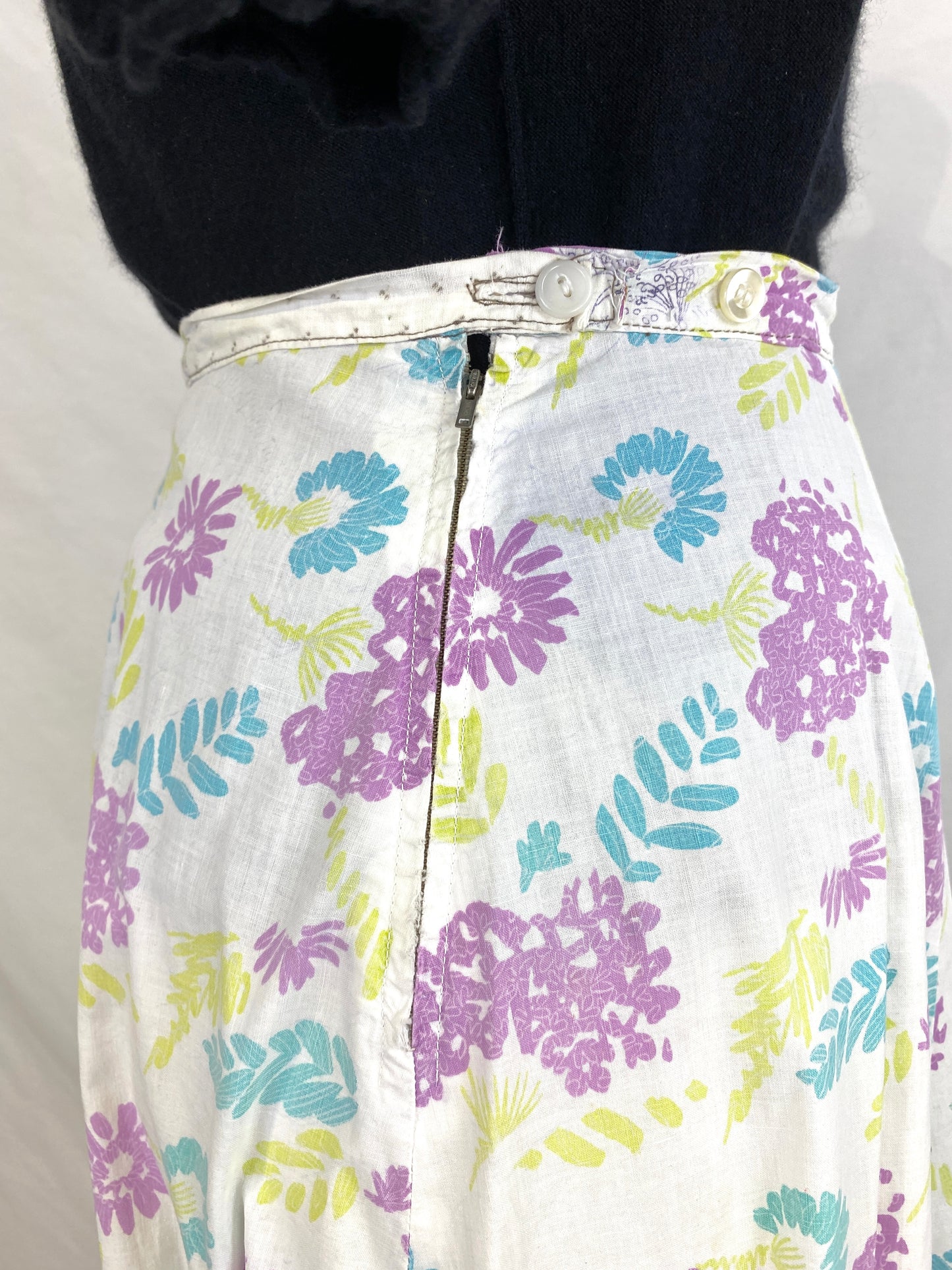 Close-up of side zipper and button closure on 50s floral print skirt. Ian Drummond Vintage.  