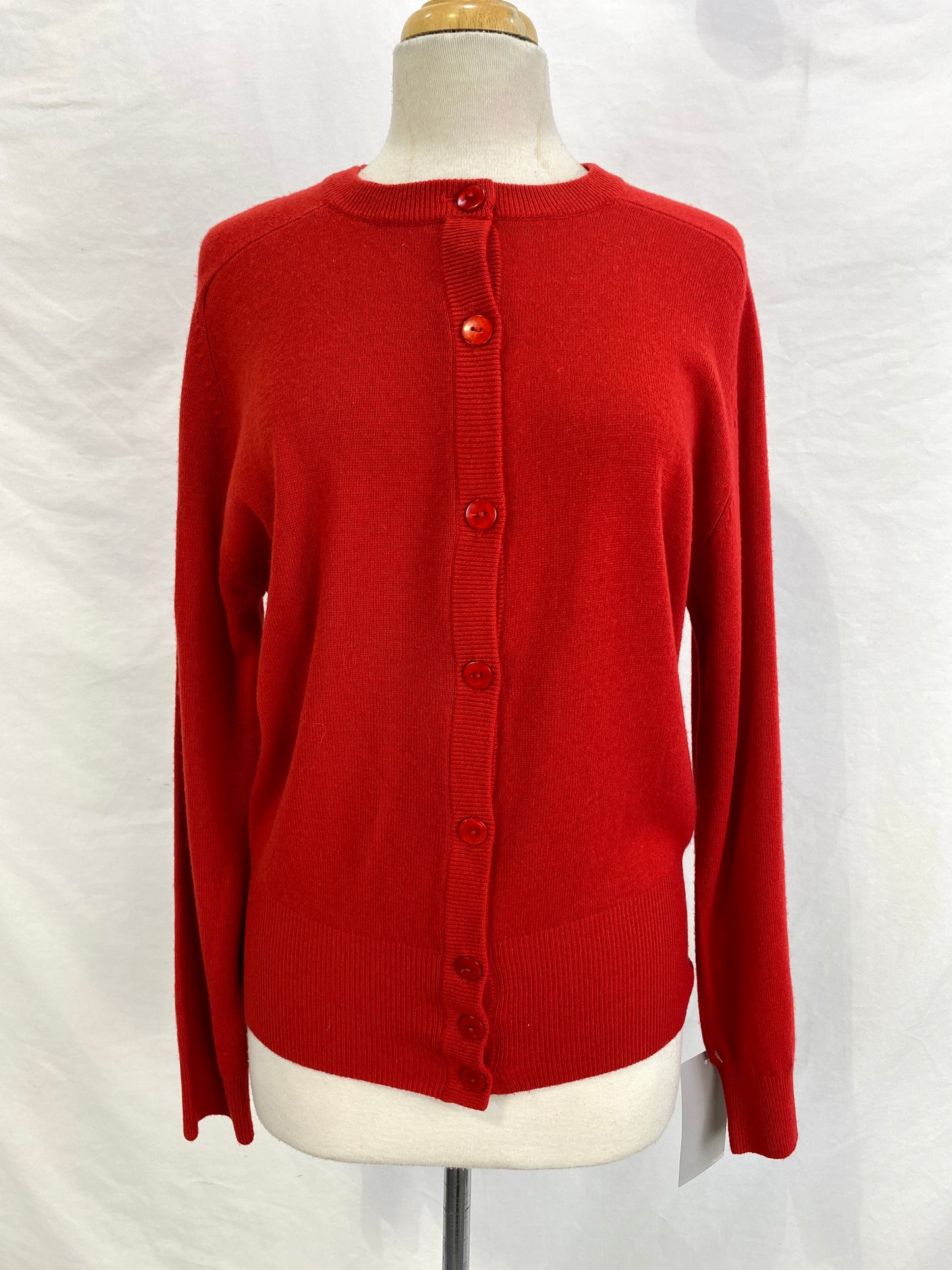 Front of red button-up cashmere cardigan on mannequin. Ian Drummond Vintage. 