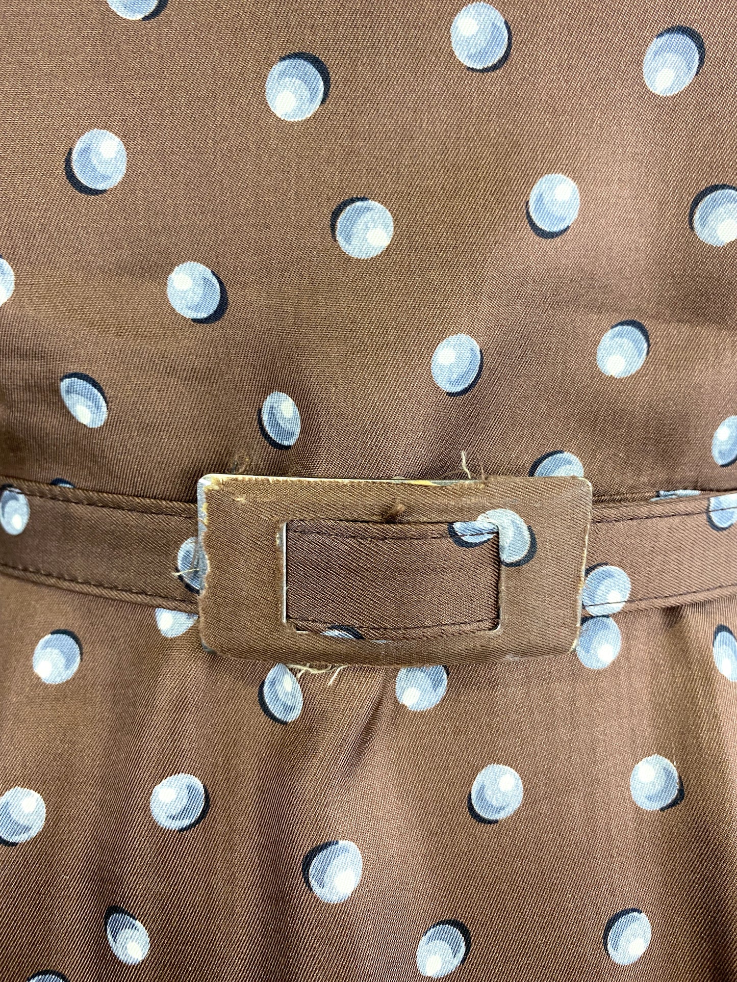 Close-up of belt buckle on 1950s brown silk dress. Ian Drummond Vintage. 
