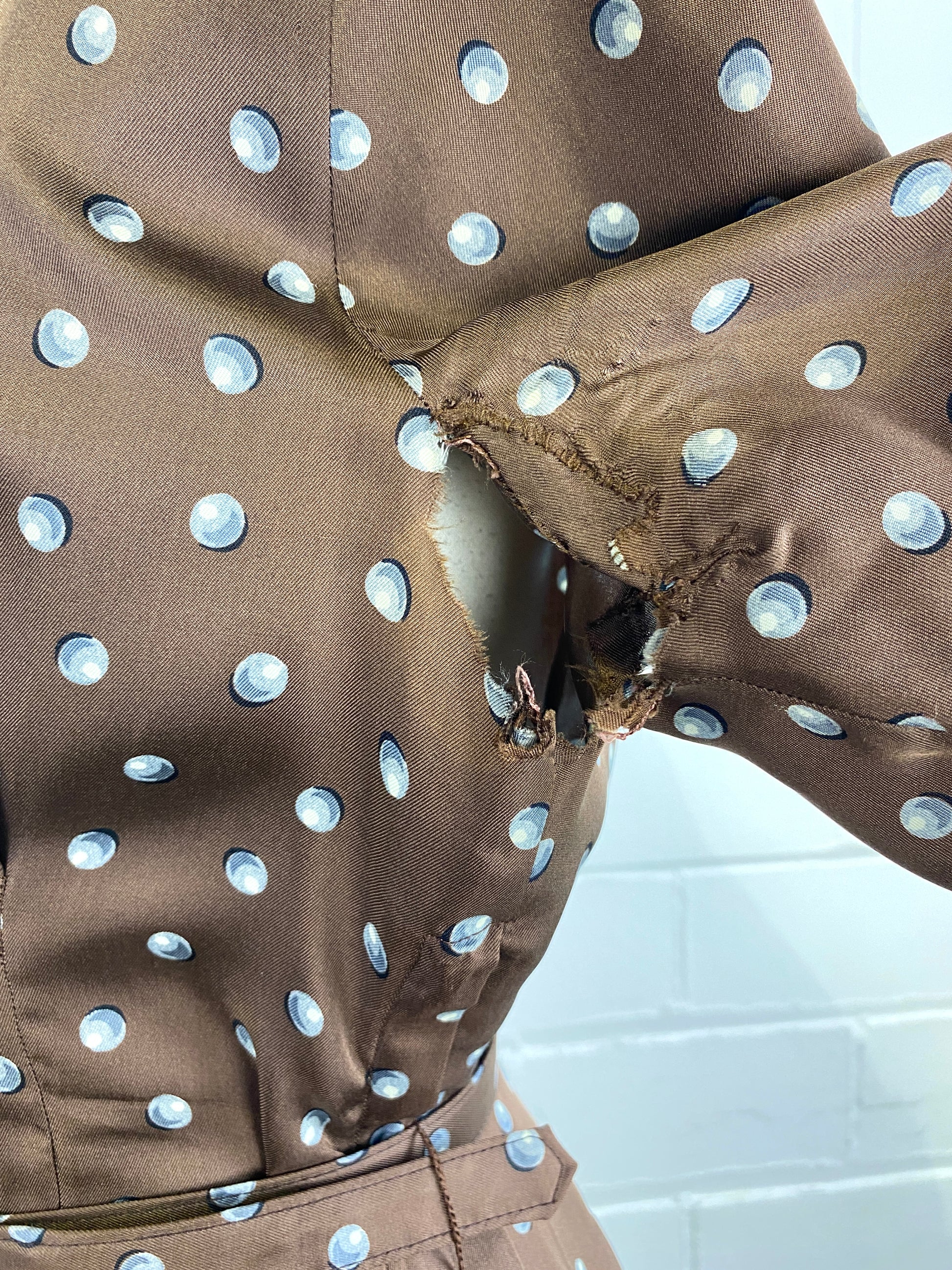Condition issue on underarm of brown silk 50s jacket. 