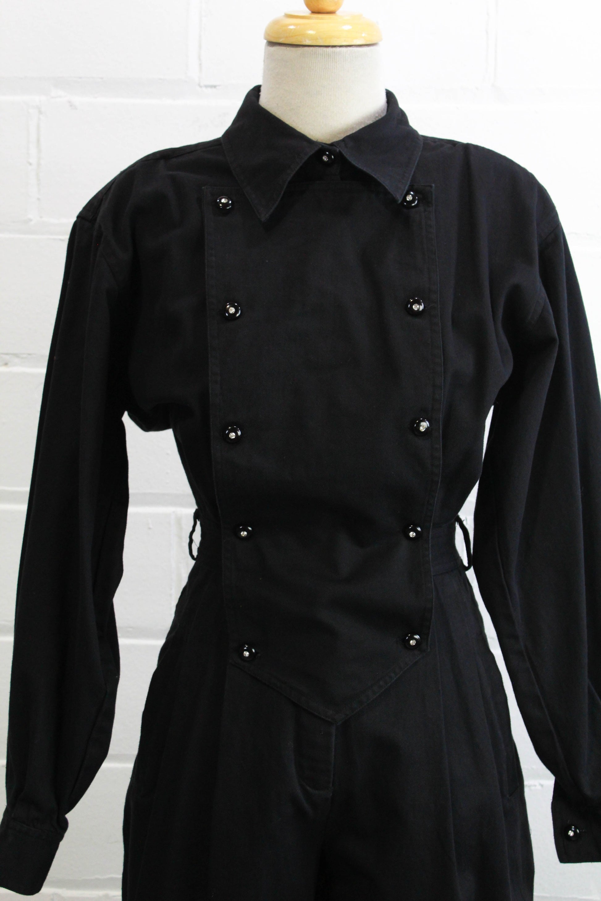 1980s womens jumpsuit black cotton with bib front, collar button up close up of front