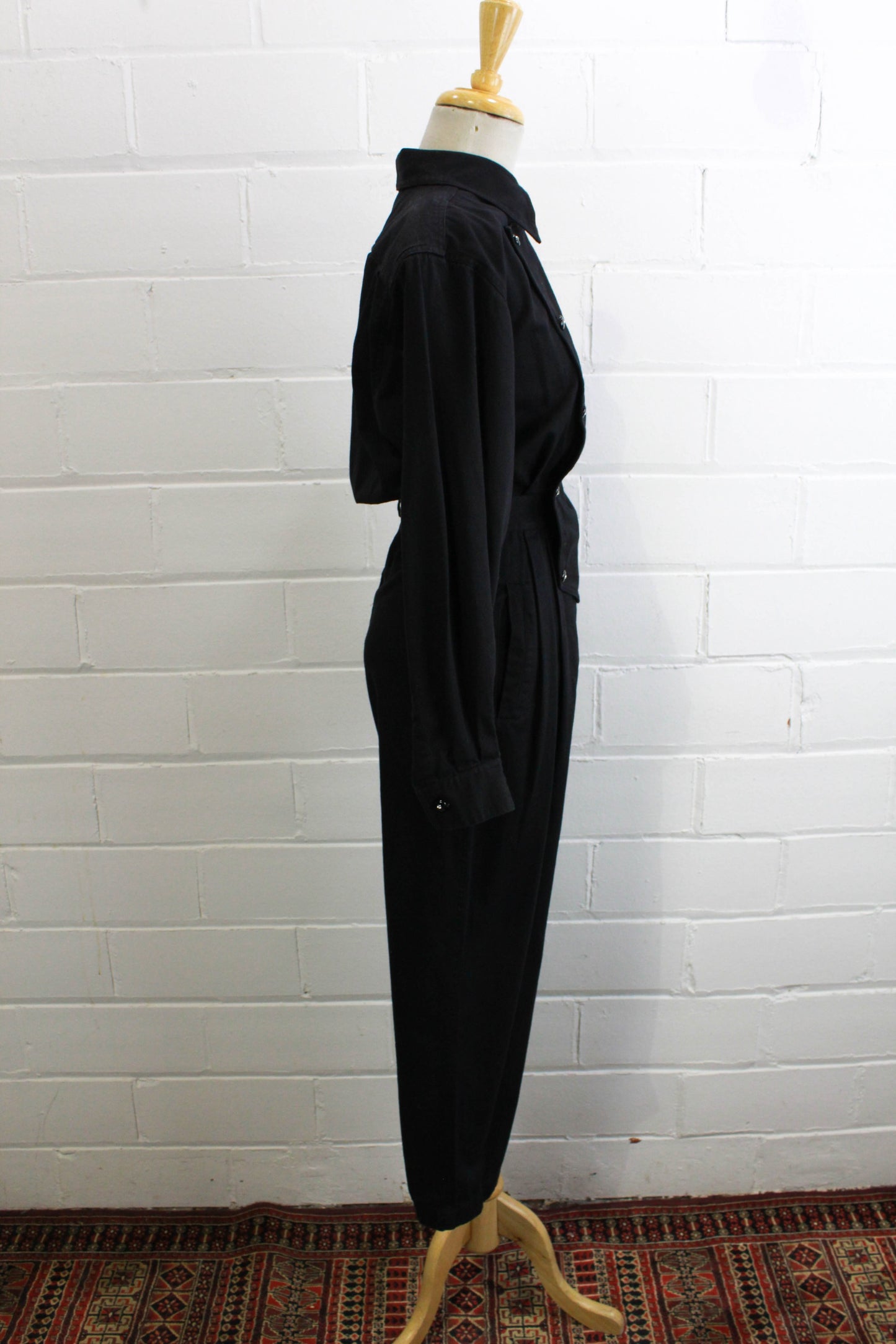 1980s womens jumpsuit black cotton with bib front, collar button up side view