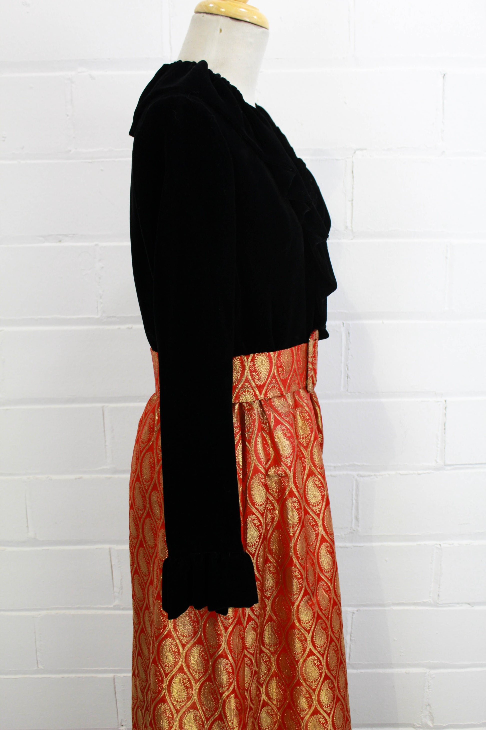 1970s maxi dress black velvet with red and gold metallic brocade skirt, ruffle collar side view close up