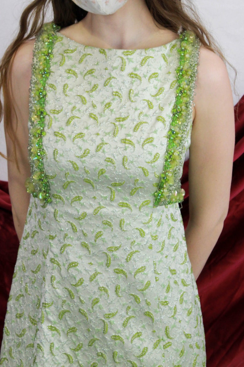 Close-up of green sleeveless paisley maxi dress. Ian Drummond Vintage.  